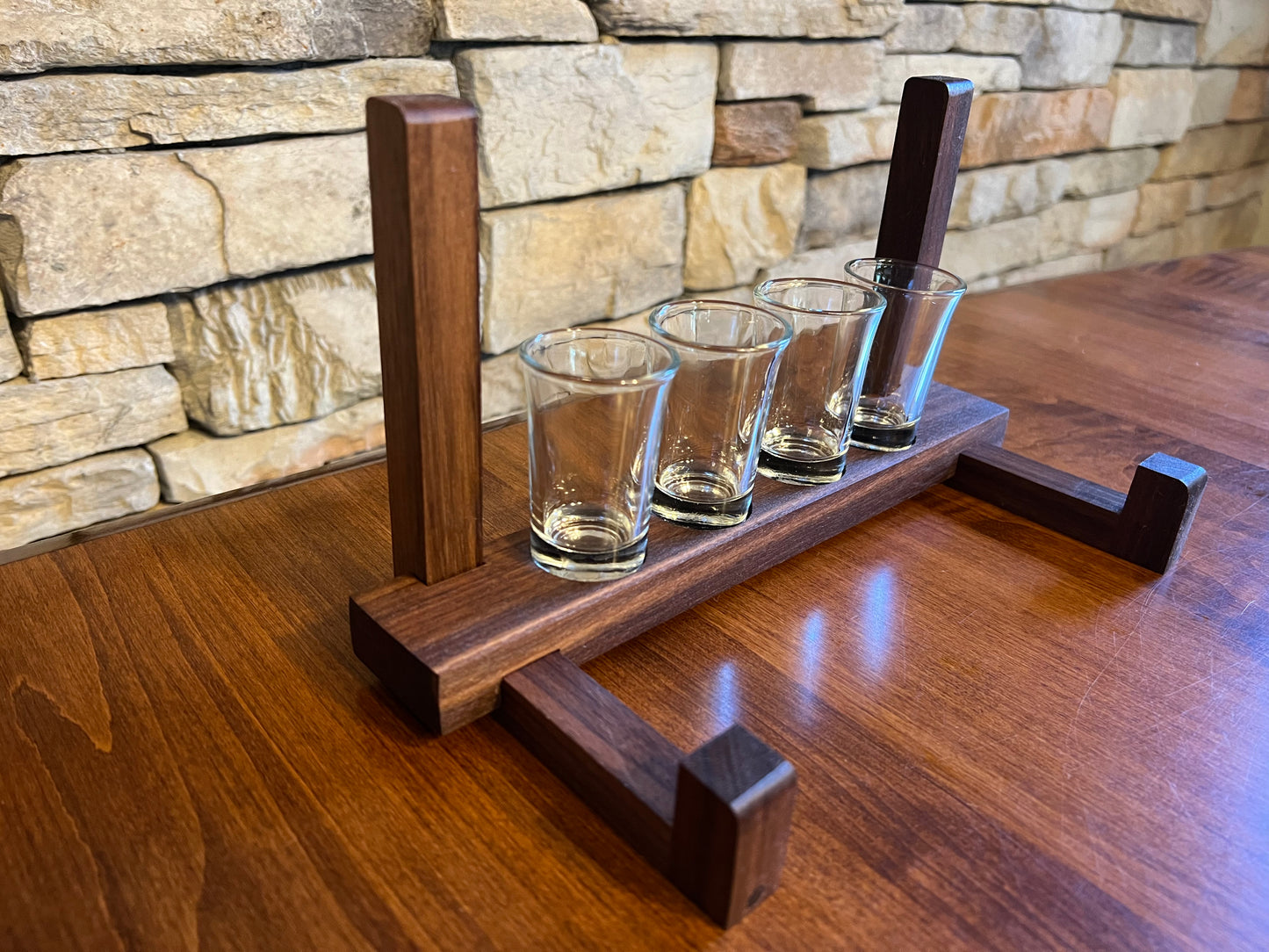 Husband gift for birthday, a personalized tequila board with his name on it with a shot tray holder that displays his gift at a home bar. The shot glasses sit in the holder for easy shot board storage.  Perfect gift for tequila barware. Tequila gift.