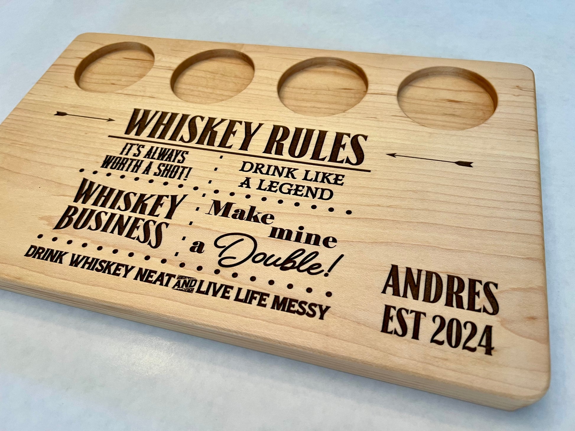 Unique gift for whiskey drinker is a whiskey rules shot board with fun whiskey sayings on it like make mine a double. Perfect gift for any whiskey, drinker or couples who like to drink whiskey together. ￼