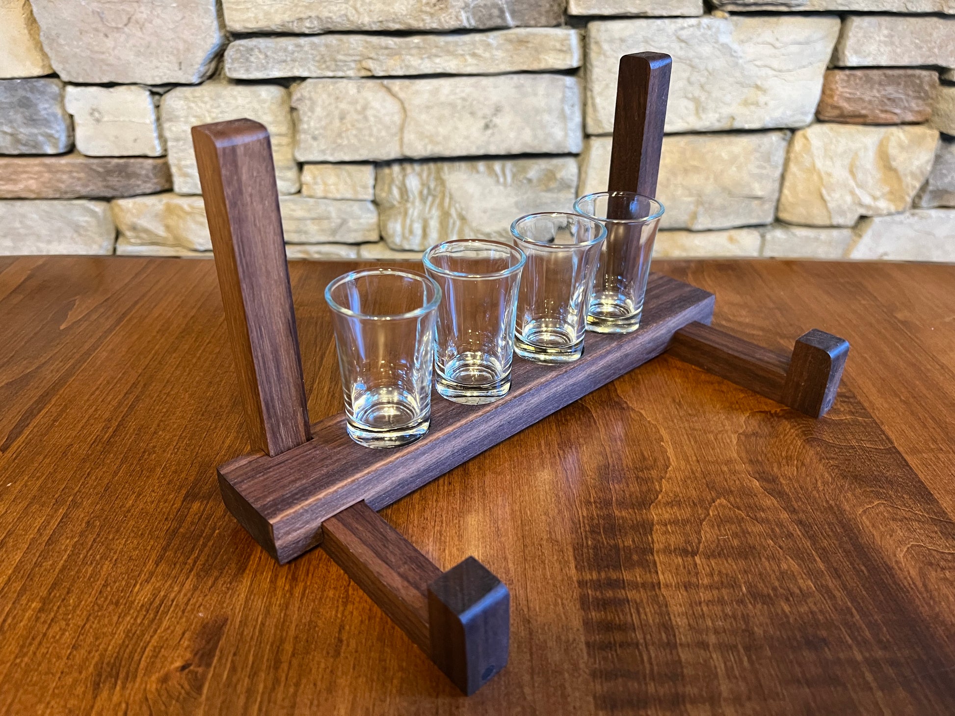 Personalized shot board holder keeps shot glasses hidden behind the shot board.