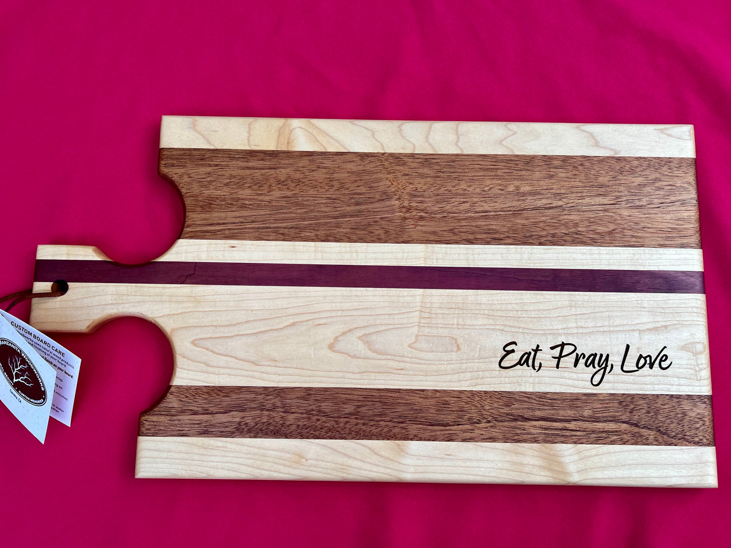 Personalized and engraved edge grain personalized and engraved edge grain cheeseboard, or breadboard. Perfect for entertaining guests.  Mahogany, purpleheart, and Maplewoods are used to create this beautiful and colorful charcuterie board ￼￼￼