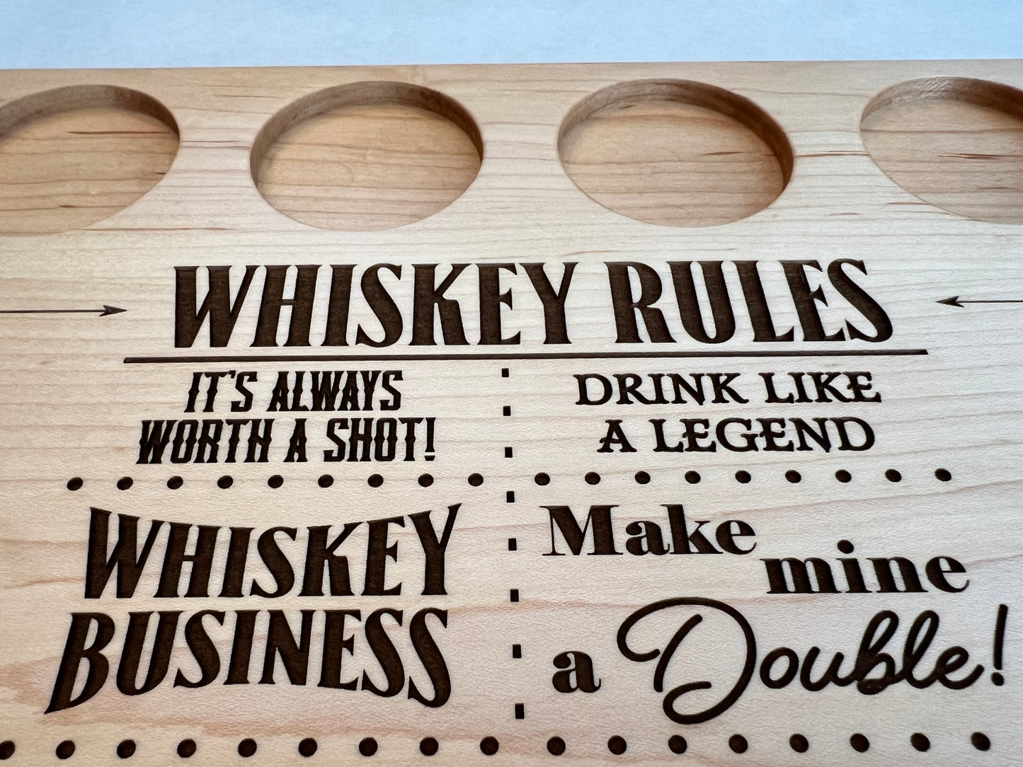 Custom whiskey board for whiskey drinker includes a hardwood board for whiskey drink flights engraved with sayings about whiskey. Personalized gift for whiskey drinker or shot drinker.